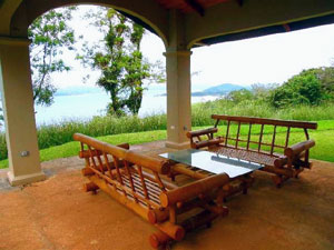 The wide patio of the lower house, furnished with two sets of outdoor furniture, is a wonderful place to enjoy the balmy climate and the views.